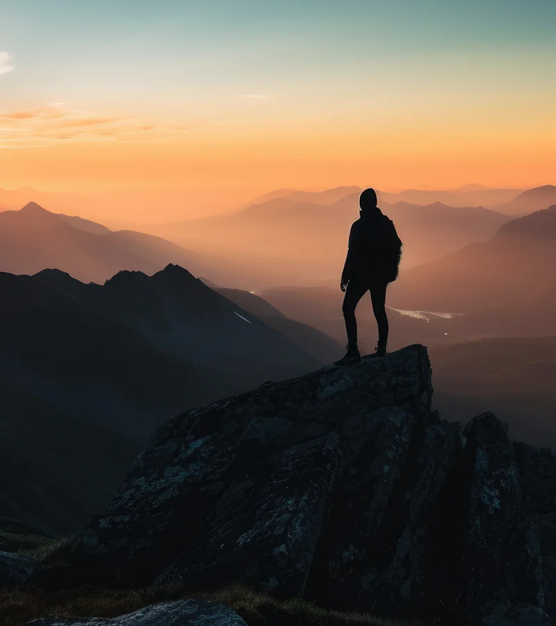 silhouette-person-standing-top-hill-beautiful-colorful-sky-morning